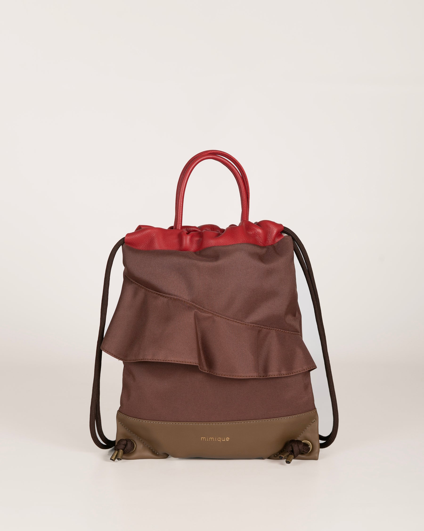 Mochila bolso Zahora mini de Mimique. De piel y loneta con volante marrón chocolate