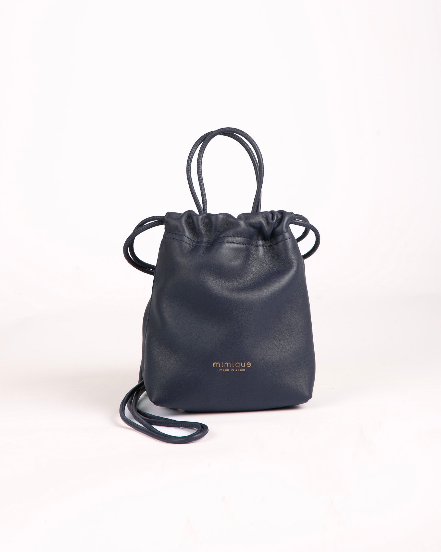 Mini bombonera para mujer Cue de Mimique en piel navy azul marino. Bandolera con asa de mano made in Spain. Gran capacidad