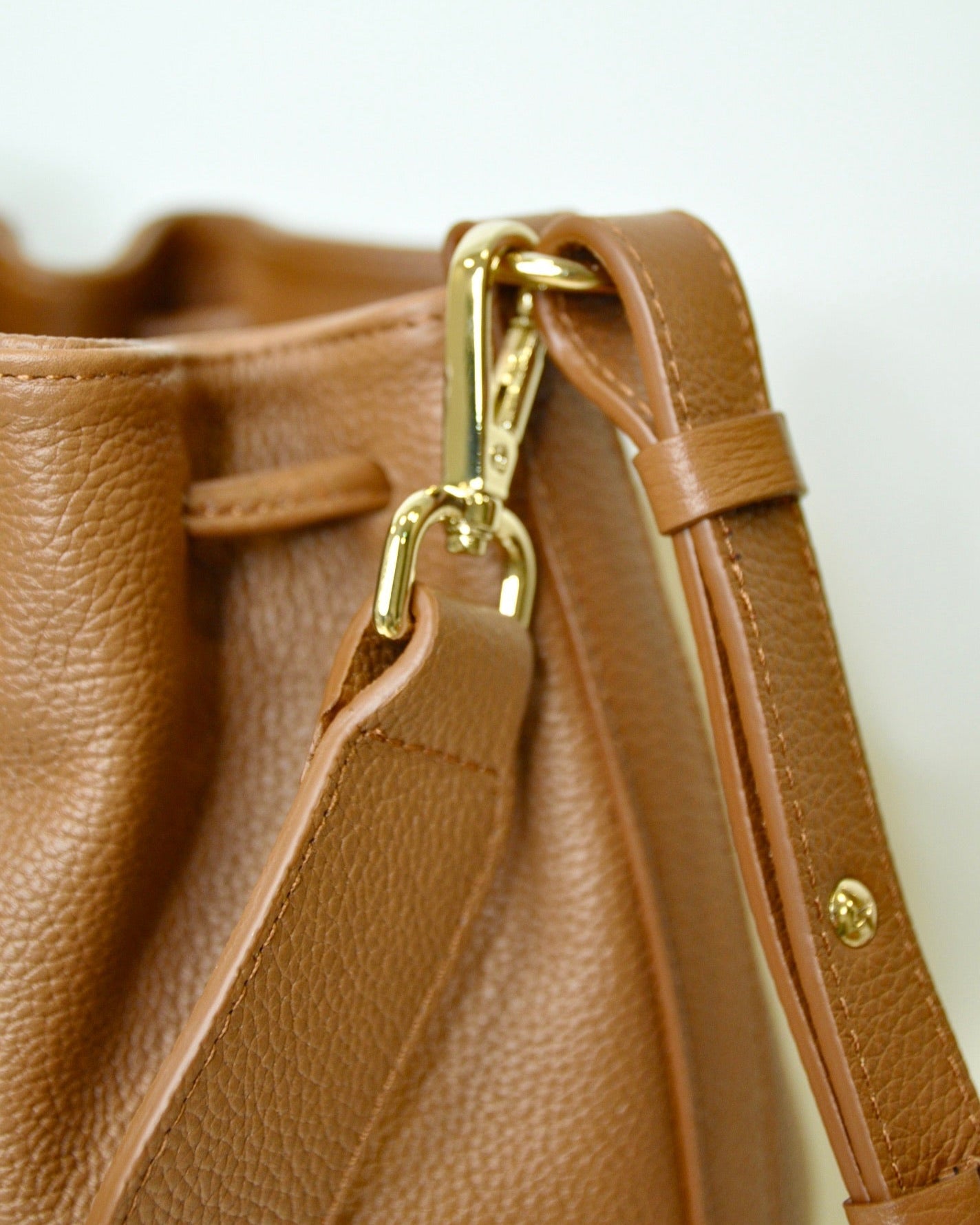 Bombonera Serín de Mimique en piel de máxima calidad color marrón cuero con asa regulable y asa de mano