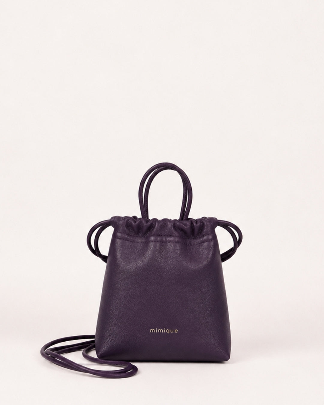 Bolso bandolera Cue color berenjena de Mimique en piel premium con diseño de bombonera elegante y versátil