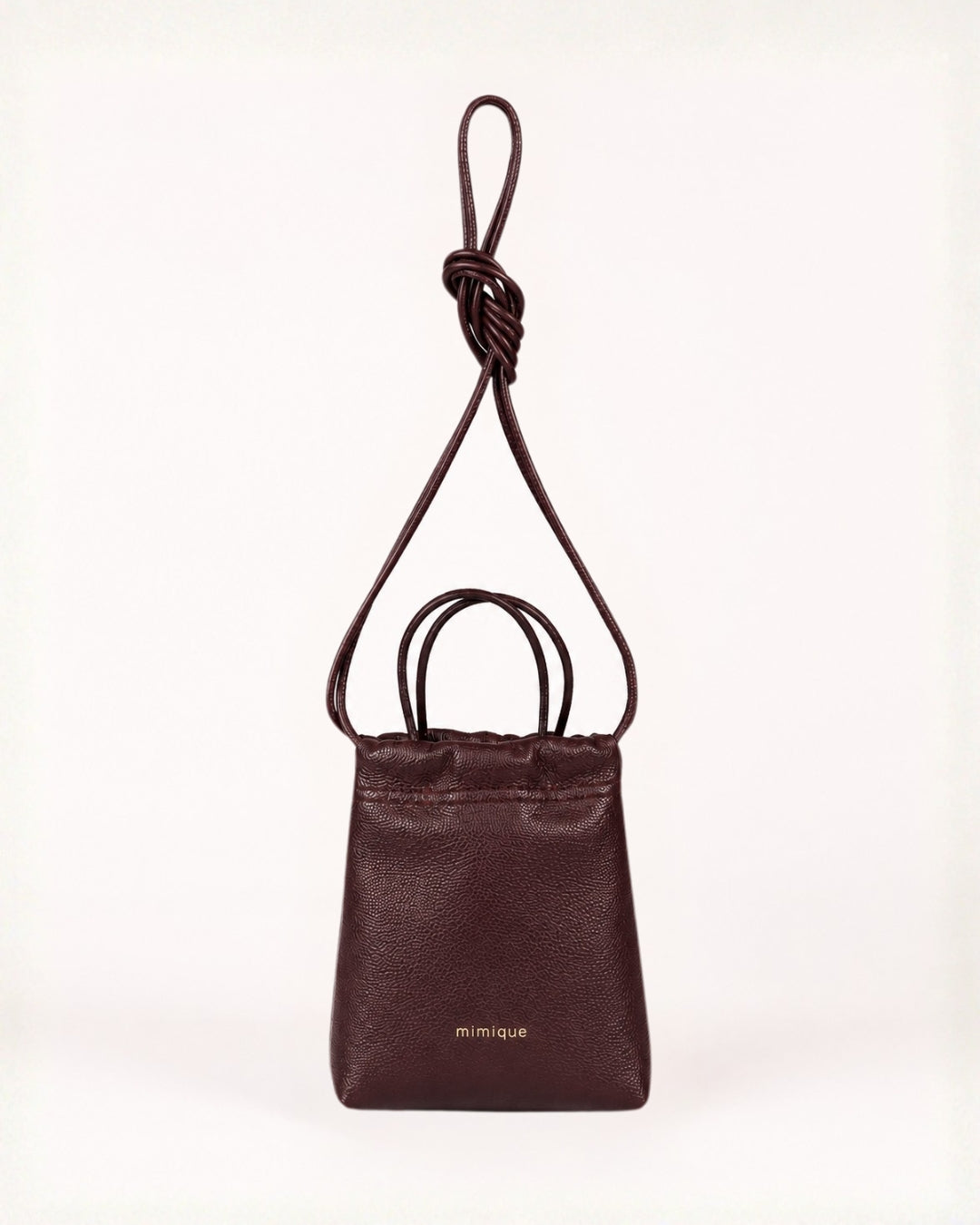Bolso bandolera de piel burdeos para mujer Cue Mimique. Calidad made in Spain